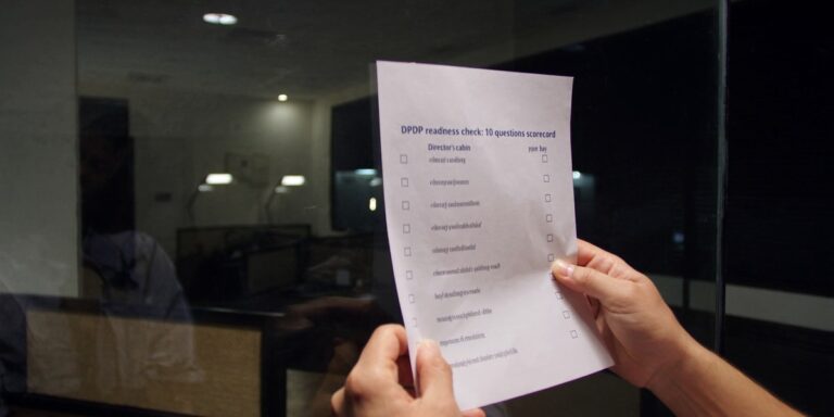 DPDP readiness check 10 questions, IT head reviewing scorecard reflection on glass cabin wall, Sirius Star