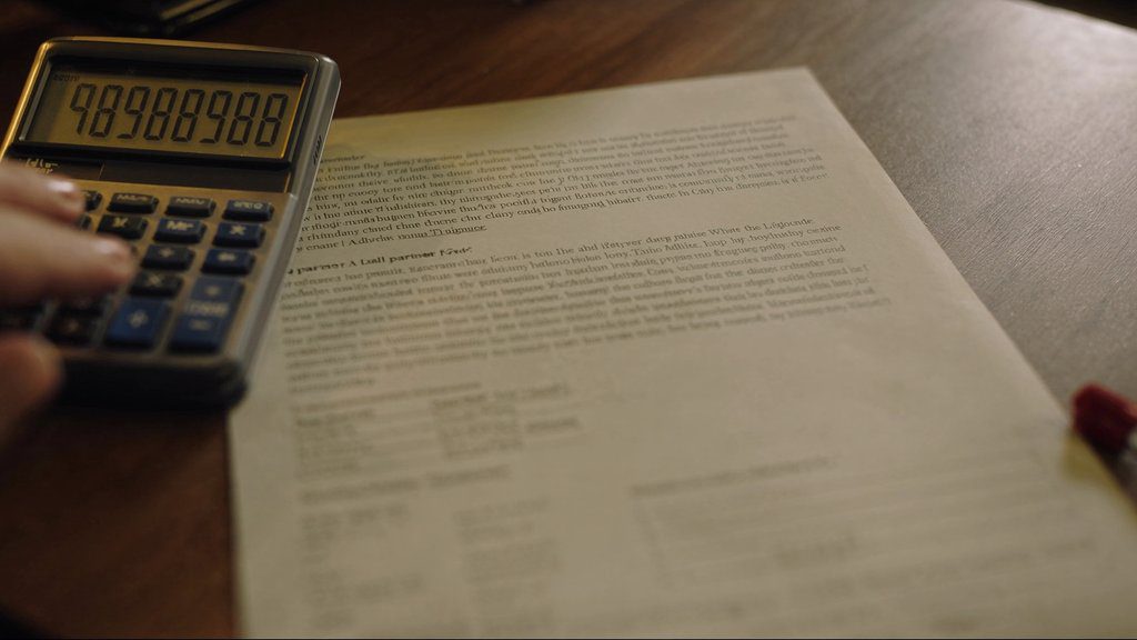 dell latitude price in india — hand on calculator next to Dell partner quote sheet, Sirius Star