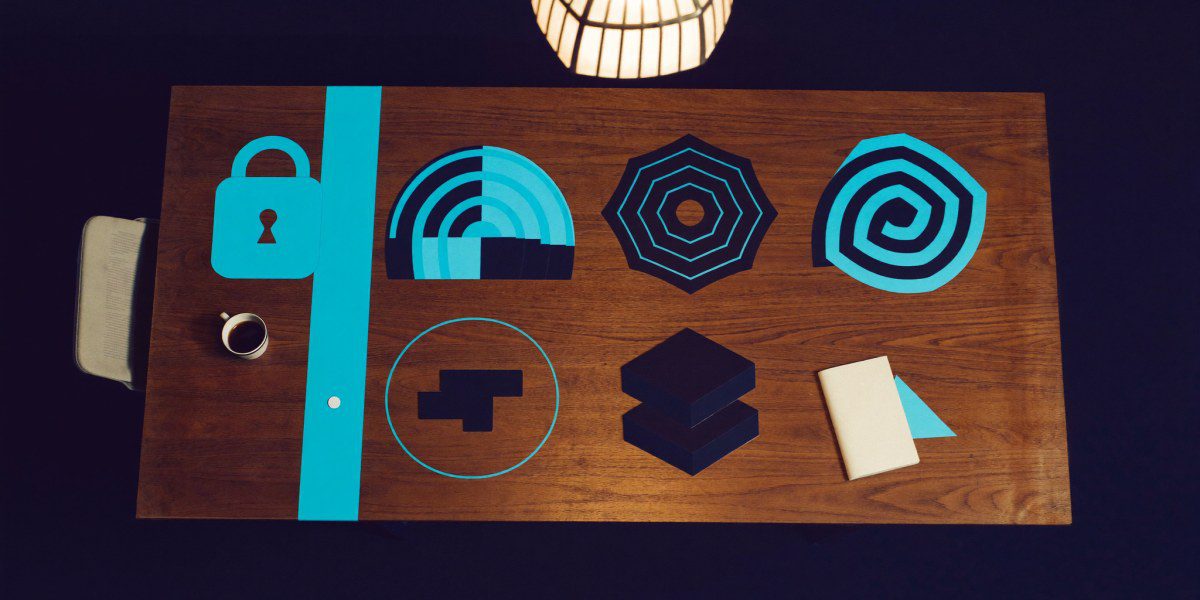 Abstract Quantum Networks zero-trust and cloud Wi-Fi flat-lay with cyan paper cutouts on a Mumbai boardroom walnut desk, Sirius Star Quantum Networks readiness review