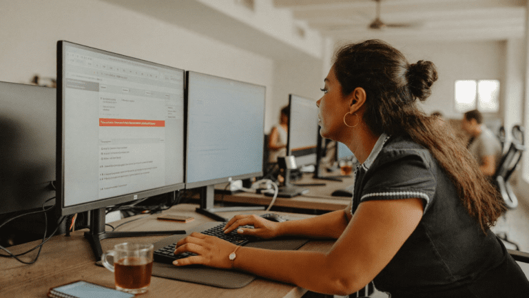 Indian woman IT manager at her desk in Pune pharma office reading EDR security alert Monday morning