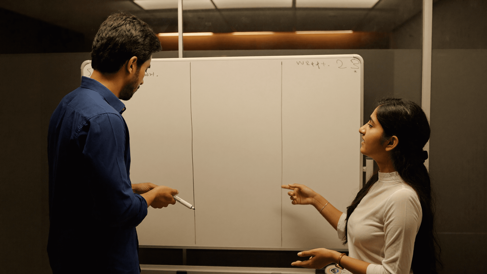 Indian SaaS co-founder and operations head debating zoho one vs microsoft 365 for indian smbs across a meeting room