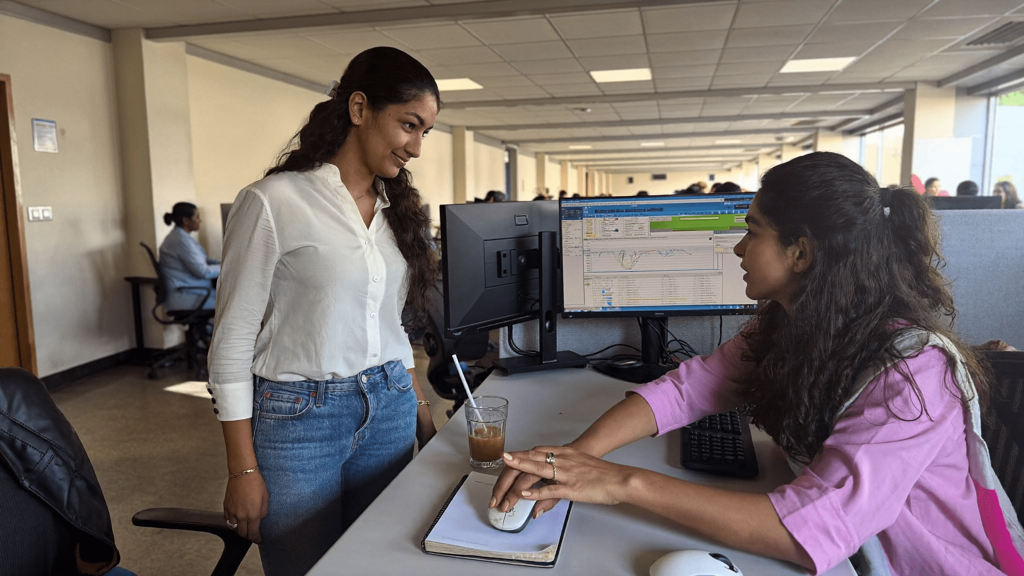 Friday floor walk: an IT lead and a finance analyst at her desk, the wrist click and the dying mouse that started the standardisation