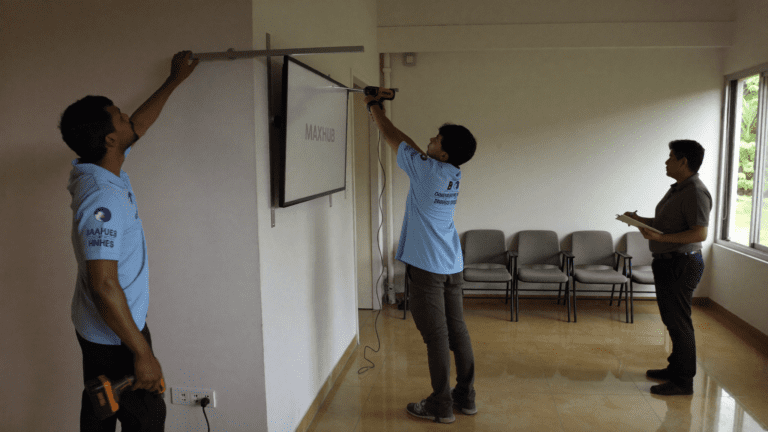 MAXHUB V6 86-inch interactive display being wall-mounted in a Pune training room